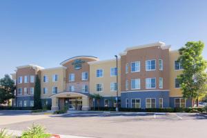 an exterior view of a hotel with a parking lot at Homewood Suites by Hilton Carlsbad-North San Diego County in Carlsbad