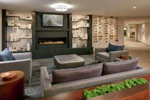 a living room with a couch and a fireplace at Hilton Garden Inn San Diego Mission Valley/Stadium in San Diego