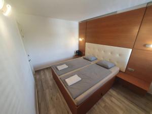 a small bedroom with a bed and a wooden cabinet at Hideaway Tenerife Holiday Apartment Las Américas in Playa Fañabe