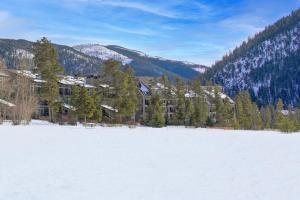 a large snow covered field in front of a building at Evergreen Condominiums by Keystone Resort in Keystone