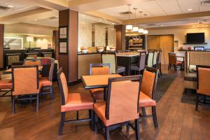 a restaurant with tables and chairs and a bar at Hampton Inn San Antonio Stone Oak in San Antonio