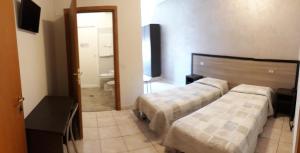 Postel nebo postele na pokoji v ubytování Hotel Salus