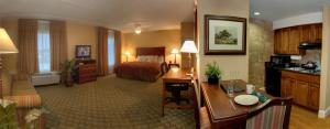 a hotel room with a bed and a living room at Homewood Suites by Hilton San Antonio North in San Antonio