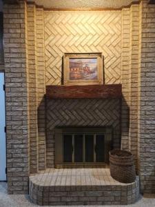 a brick fireplace with a picture on top of it at Terry Kuhlman in San Angelo