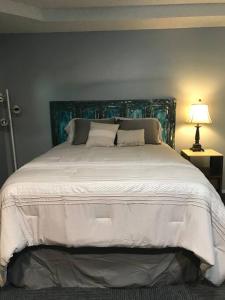 a bedroom with a large white bed with a blue headboard at Terry Kuhlman in San Angelo