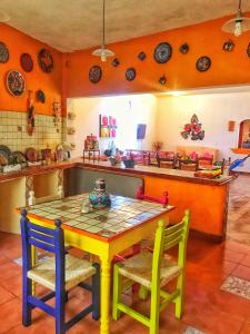 uma cozinha colorida com uma mesa e cadeiras em Quinta Villamarim em Chiconcuac