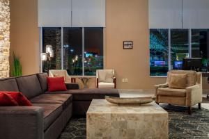 a living room with couches and chairs and a table at DoubleTree by Hilton Hotel Savannah Airport in Savannah