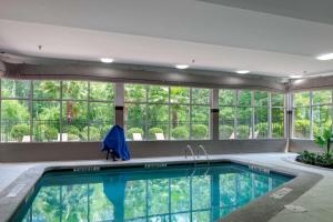 a swimming pool in a house with windows at DoubleTree by Hilton Hotel Savannah Airport in Savannah