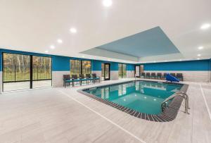 una piscina en un hotel con paredes y ventanas azules en Hampton Inn & Suites Benton Harbor, MI, en Benton Harbor