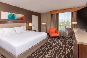 a hotel room with a bed and a desk and a chair at DoubleTree by Hilton San Bernardino in San Bernardino