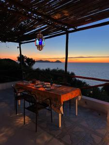 a table on a patio with a view of the ocean at casavictoria in Ponza