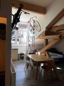 a room with a table and a bike hanging on the wall at Bikers Paradise Apartment in Oberlängenfeld