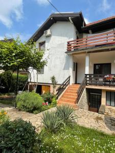 a house with stairs and plants in front of it at 5min Airport in Surčin +14 photos