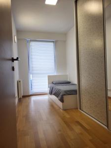 een slaapkamer met een bed en een glazen schuifdeur bij Luxurios Apartment Sarajevo in Sarajevo