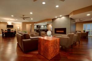 a large living room with couches and a fireplace at Embassy Suites by Hilton Scottsdale Resort in Scottsdale