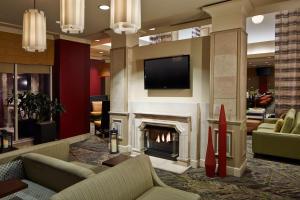 a living room with a fireplace and a television at Hilton Garden Inn Scottsdale Old Town in Scottsdale