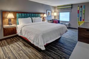 a hotel room with a large bed and a desk at Hampton Inn New Albany Louisville West in New Albany +27 photos
