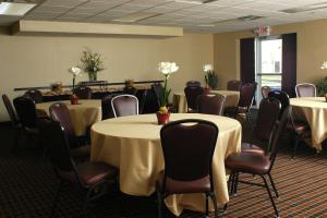 a conference room with tables and chairs with white flowers on them at Homewood Suites by Hilton Louisville-East in Louisville