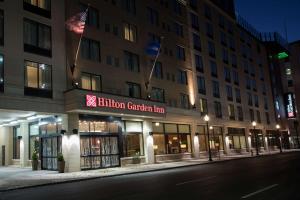 a building on a city street at night at Hilton Garden Inn Louisville Downtown in Louisville