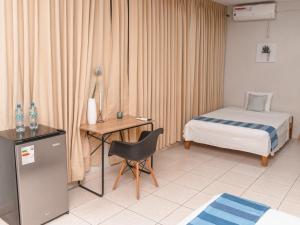 a hotel room with a bed and a desk with a chair at Leveint Executive Hotel in Pucallpa