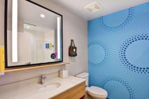 a bathroom with a sink and a blue shower at Tru By Hilton Shepherdsville Louisville South in Shepherdsville +20 photos