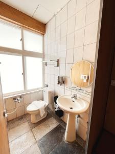 a bathroom with a toilet and a sink at 20ft Sea Attic in Green Island +100 photos