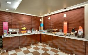 a large kitchen with wooden walls and a counter at Hampton Inn Salt Lake City/Sandy in Sandy