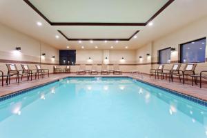 a large swimming pool with chairs and tables at Hampton Inn Seattle/Everett Downtown in Everett