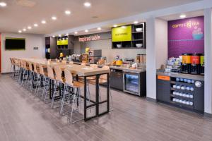 a cafeteria with a long table and chairs in a store at Home2 Suites By Hilton DuPont in DuPont