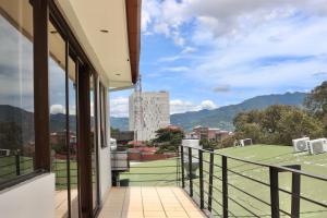 a balcony with a view of a tennis court at Hotel La Amistad in San José