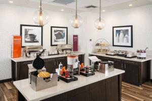 a kitchen with a counter with aasteryasteryasteryasteryasteryasteryasteryasteryastery at Hampton Inn & Suites by Hilton Seattle/Northgate in Seattle