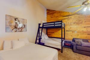 a bedroom with two bunk beds and a couch at Silver Lodge B in Granby
