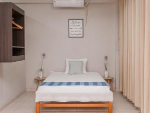 a bedroom with a bed and two side tables at Leveint Executive Hotel in Pucallpa