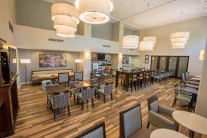 a dining room with tables and chairs in a restaurant at Hampton Inn & Suites Berkshires-Lenox in Lenox