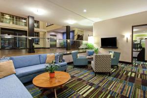 a lobby with a blue couch and chairs and a table at Hampton Inn Morgan Hill in Morgan Hill