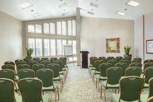 an empty room with chairs and a podium at DoubleTree by Hilton Campbell - Pruneyard Plaza in Campbell +42 photos