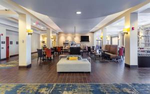 a lobby with tables and chairs and a waiting room at Hampton Inn Salt Lake City Downtown in Salt Lake City