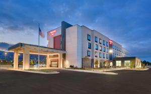 a hotel building with a flag in a parking lot at Hampton Inn Draper Salt Lake City, Ut in Draper