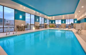 a swimming pool in a hotel with windows at Hampton Inn Draper Salt Lake City, Ut in Draper