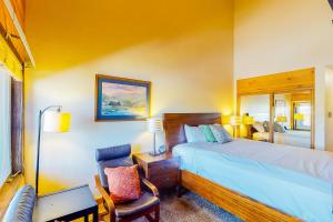 a bedroom with a bed and a desk and a chair at Silver Lodge A & B in Granby +52 photos
