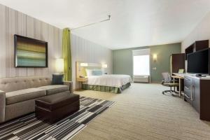 a hotel room with a bed and a couch at Home2 Suites by Hilton Salt Lake City-Murray, UT in Murray
