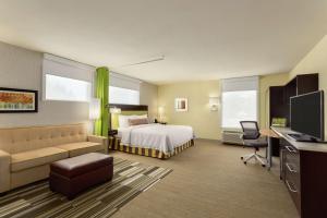 a hotel room with a bed and a couch at Home2 Suites by Hilton Lehi/Thanksgiving Point in Lehi