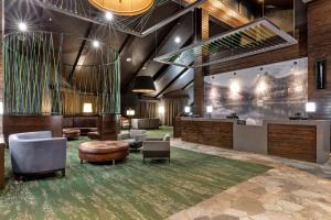 a lobby with a waiting area with chairs and tables at DoubleTree by Hilton Park City - The Yarrow in Park City