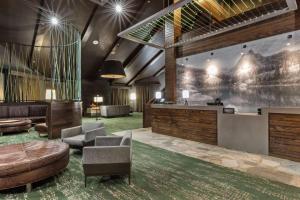 a lobby with a bar and a couch and chairs at DoubleTree by Hilton Park City - The Yarrow in Park City