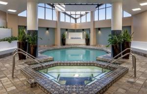 a pool in the middle of a building with columns at Doubletree Suites by Hilton Salt Lake City in Salt Lake City