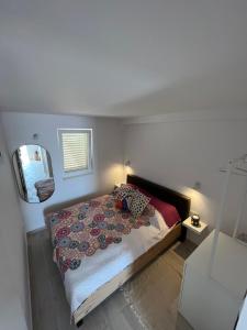 a bedroom with a bed and a mirror at Apartments old town Hvar sea view in Hvar