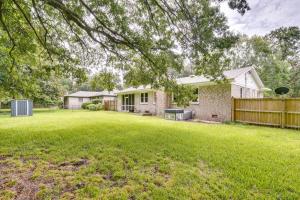 a yard with a house and a fence at Charleston Vacation Home 6 Mi to Downtown and Beach! in Charleston
