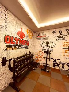 a gym with a wall with stickers on it at ابراج التحلية ريزيدنس Tahlia Towers Residence in Al Khobar