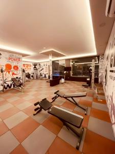 a gym with several exercise equipment in a room at ابراج التحلية ريزيدنس Tahlia Towers Residence in Al Khobar