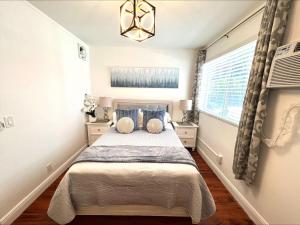 a bedroom with a bed and a window at The Pearl Beachside Apartments on Hollywood Beach in Hollywood